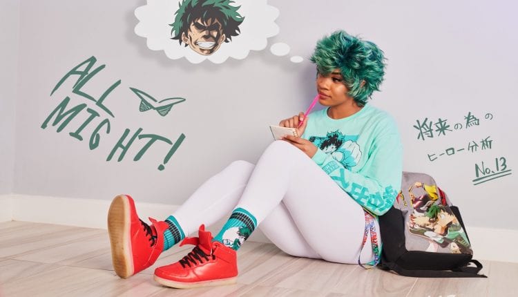 BCC dressed as Deku from My Hero Academia with a teal hoodie, white leggings, red shoes and teal wig. sitting down dreaming of being a buff super