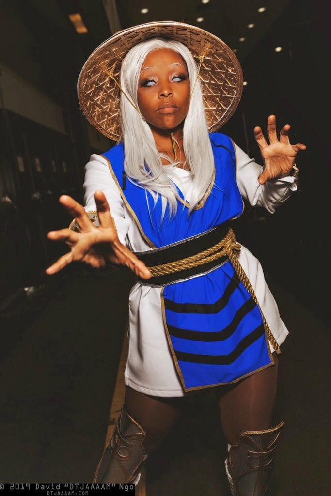 Francheezy cosplaying as Raiden from Mortal Kombat with a white wig, white contacts, and the blue and white uniform.