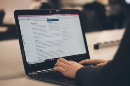 Best Assignment Writing and CV Writing Tips for Students and Graduates person typing on laptop